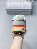 Rear view of a grey Premiata sneaker showing the orange heel detail, printed midsole and branded heel panel; image text shows 2607 TYD110A20 and 38–46.