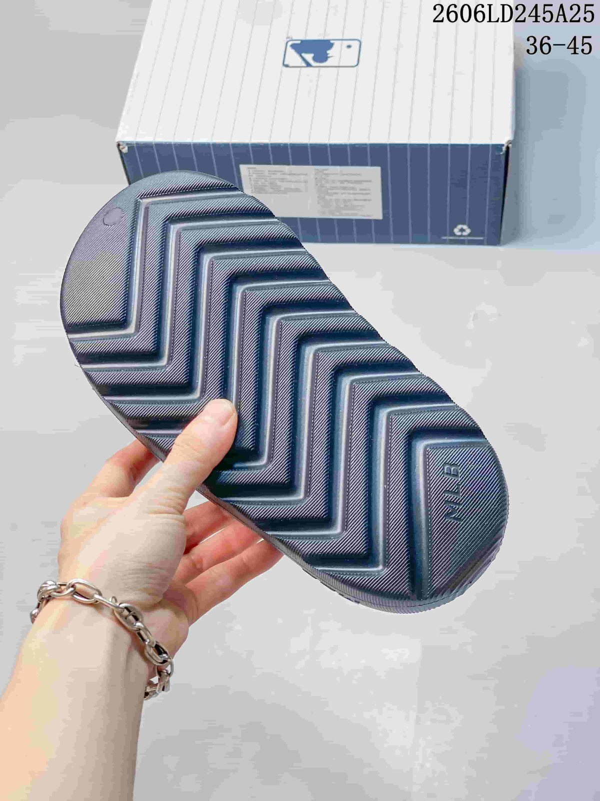 Close view of the black sandal outsole, showing the molded zigzag tread pattern and textured surface.
