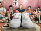 Front view of white lace-up Nike basketball sneakers with perforated toe panels