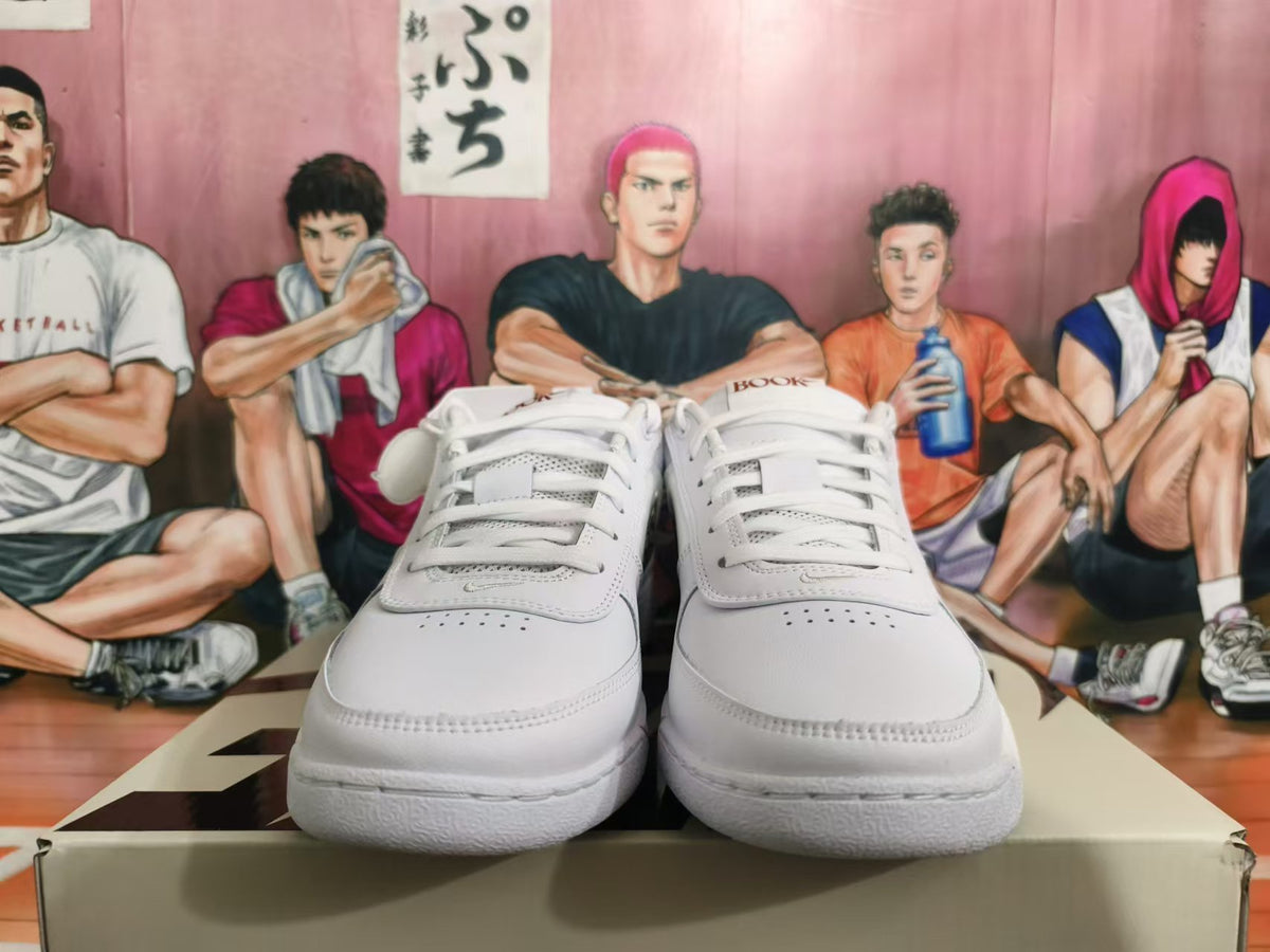 Front view of white lace-up Nike basketball sneakers with perforated toe panels