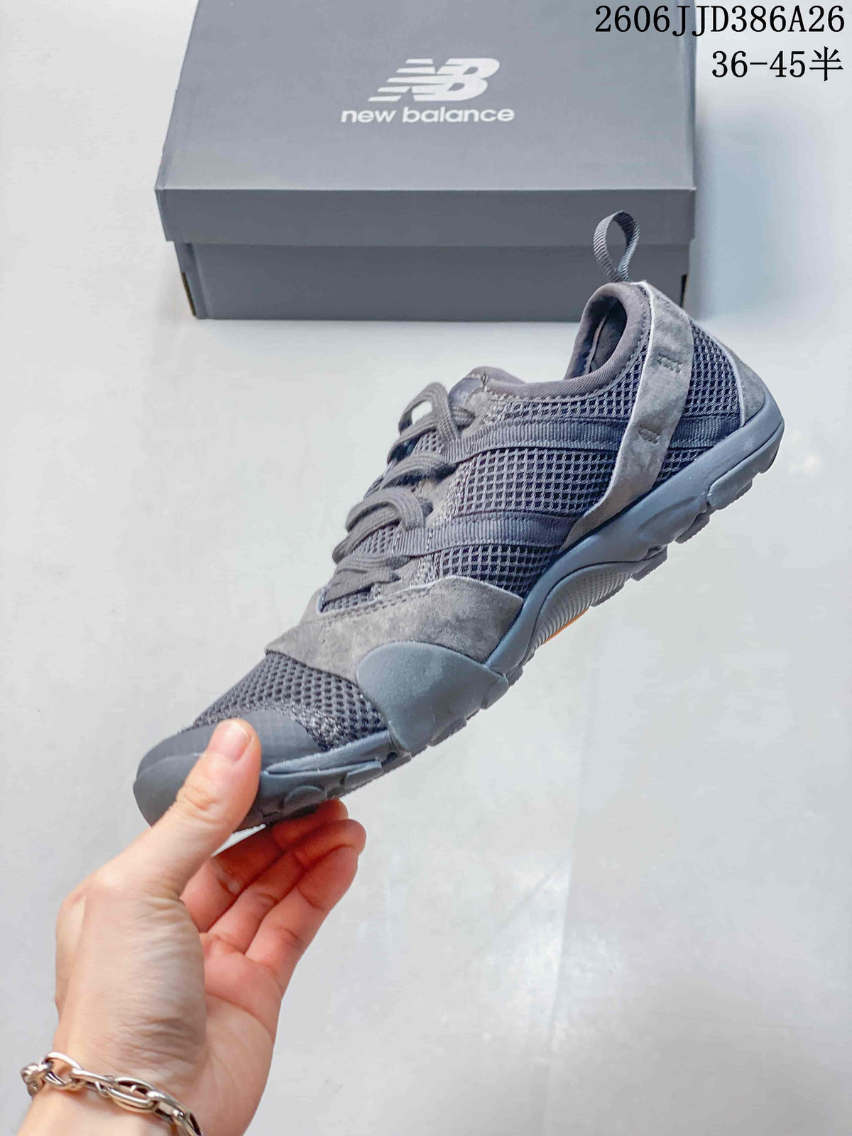 Side profile of the grey low-top sneaker showing mesh panels, overlays, and the textured outsole.