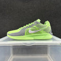 Side view of a bright green and gray Nike low-top basketball shoe with a silver-tone Swoosh.