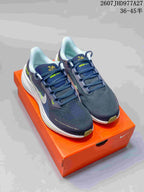 Pair of navy Nike low-top running sneakers displayed on an orange shoe box, with white midsoles and lime accents.