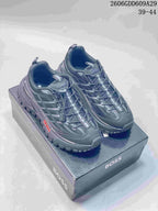 Pair of gray BOSS sneakers with a chunky treaded outsole, displayed on a branded box.