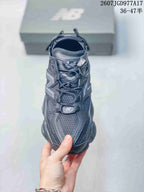 Top view of the New Balance 9060 sneaker showing the lace-up closure, mesh tongue, tongue branding, and contrasting overlays.