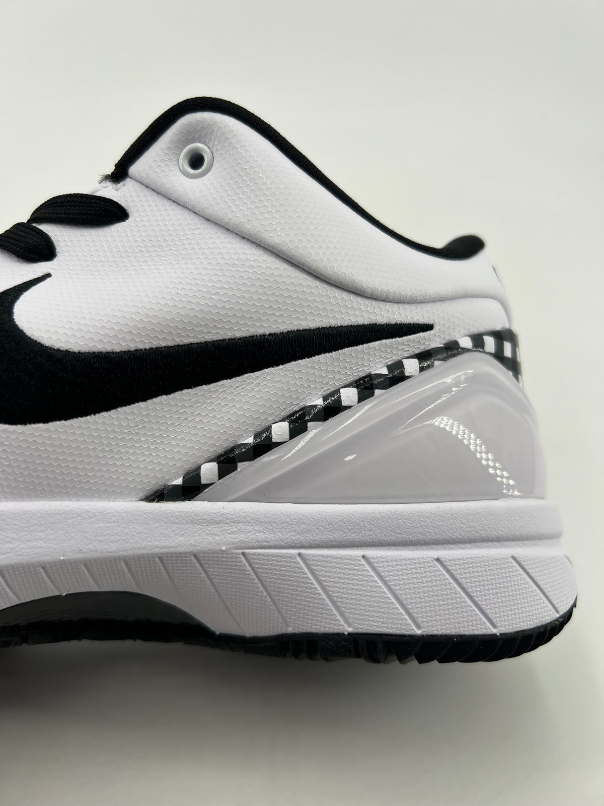 Close-up of the heel-side checkerboard trim and white midsole