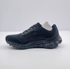 Side view of the plain black outer profile, showing the lace-up upper and segmented outsole.