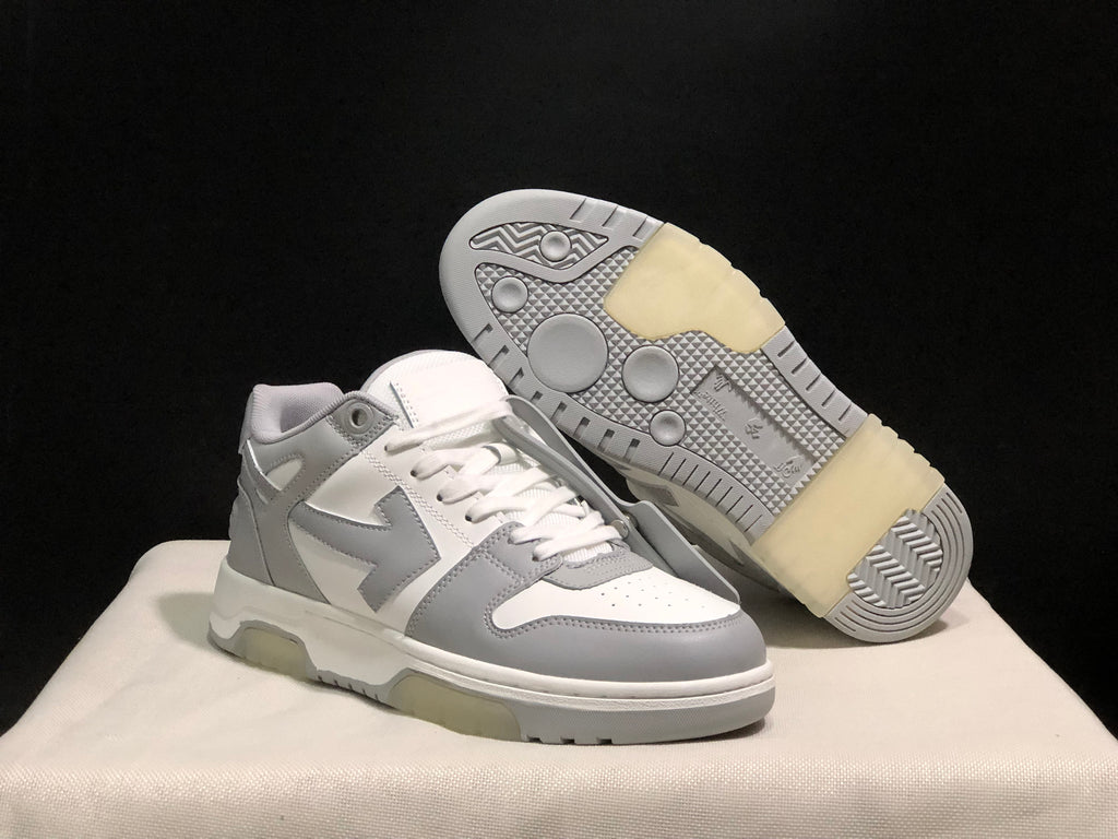 Angled product view with one sneaker lifted to reveal the patterned outsole and translucent sections.