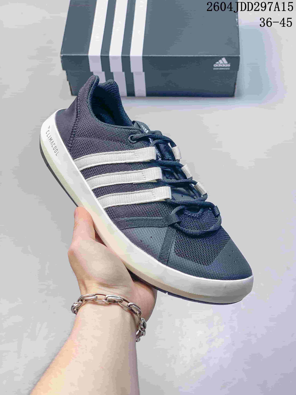 Angled side view of the navy and white adidas Terrex CC Boat shoe showing the mesh upper, layered overlays, and white midsole.
