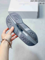 Close view of the gray sneaker outsole showing patterned rubber sections and a central dark insert labeled SPEEDBOARD.