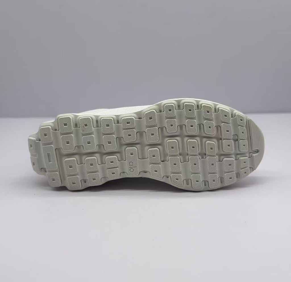Bottom view of the sneaker outsole with a segmented geometric tread pattern.