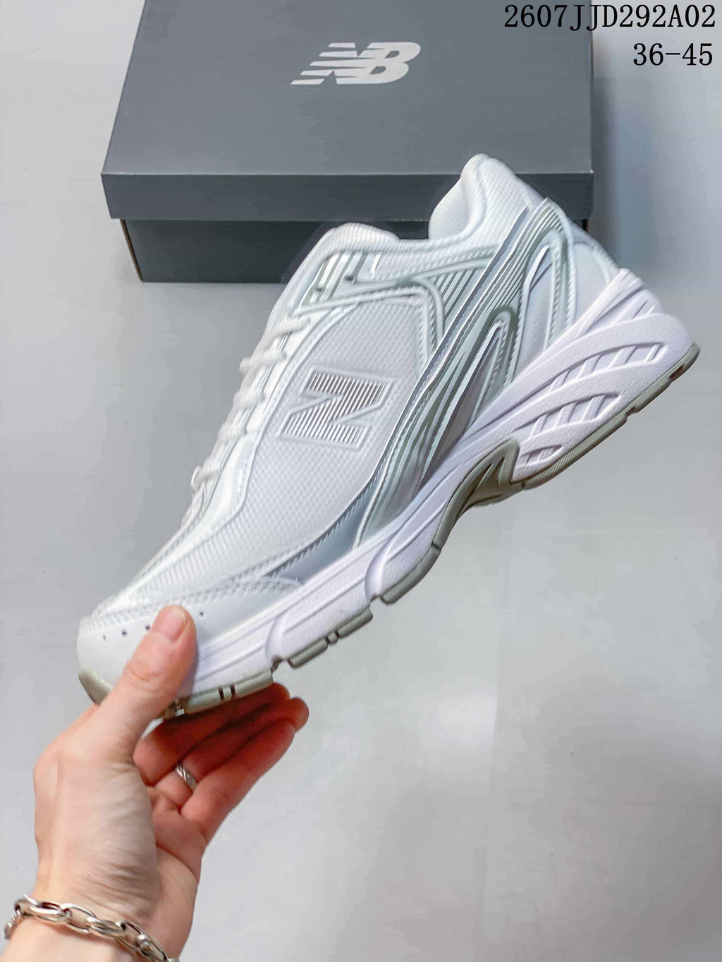 Side profile of the New Balance 509 sneaker showing the layered panels, large side logo and sculpted white sole.