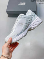 Side profile of the New Balance 509 sneaker showing the layered panels, large side logo and sculpted white sole.