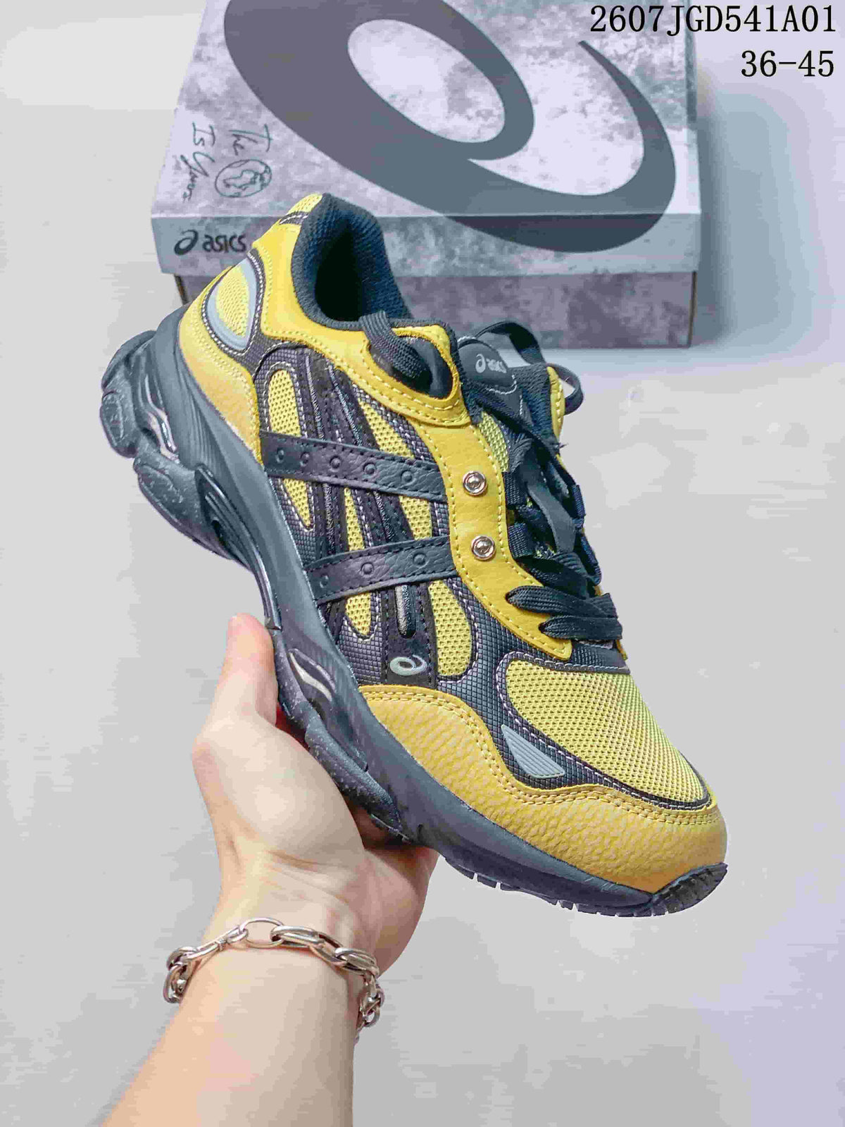 Angled side view of the yellow and charcoal sneaker