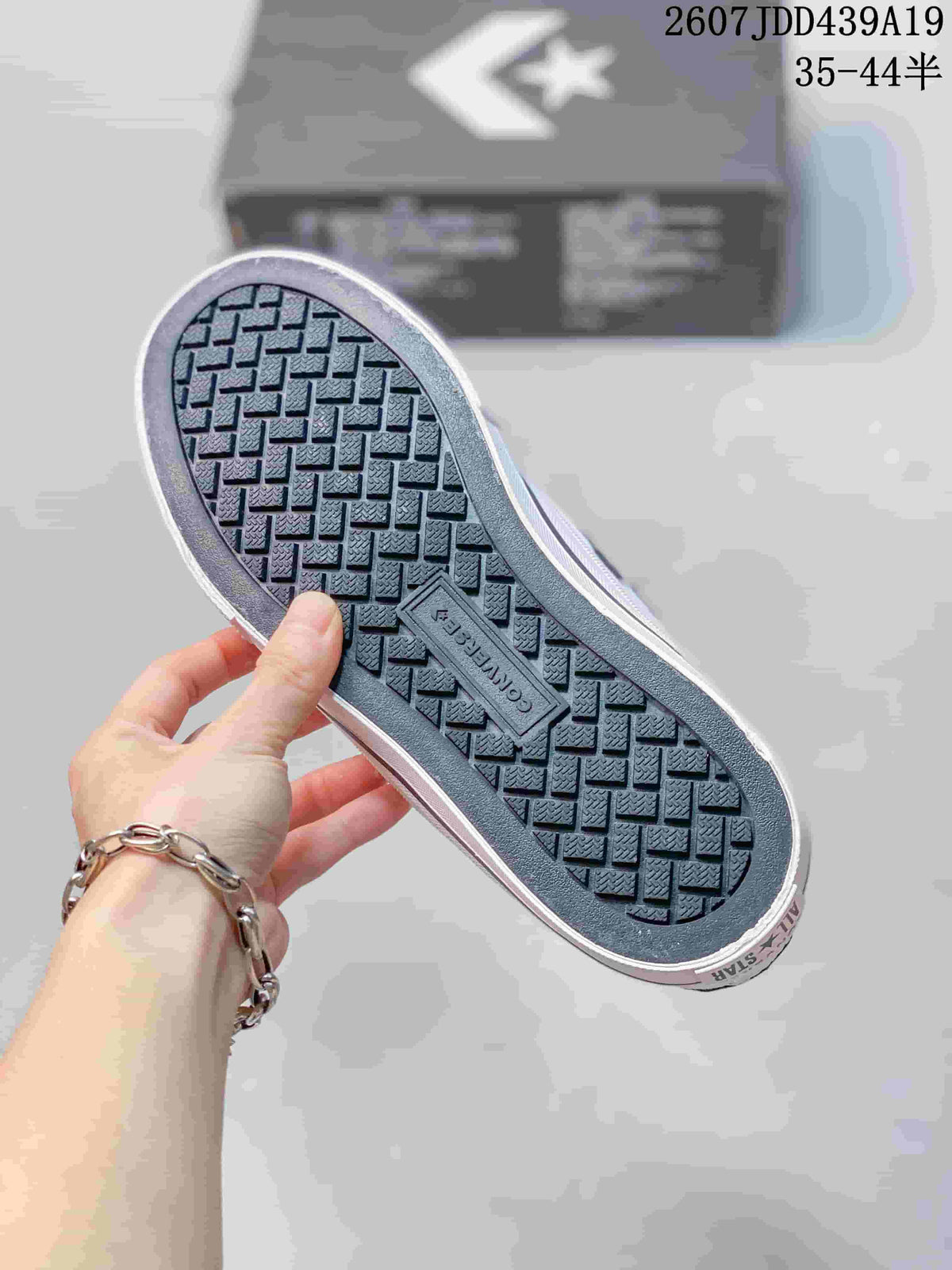 Close view of the sneaker outsole showing a repeating textured tread pattern and Converse branding.