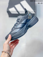 Side profile showing the layered upper panels, lace-up front, and sculpted black sole.