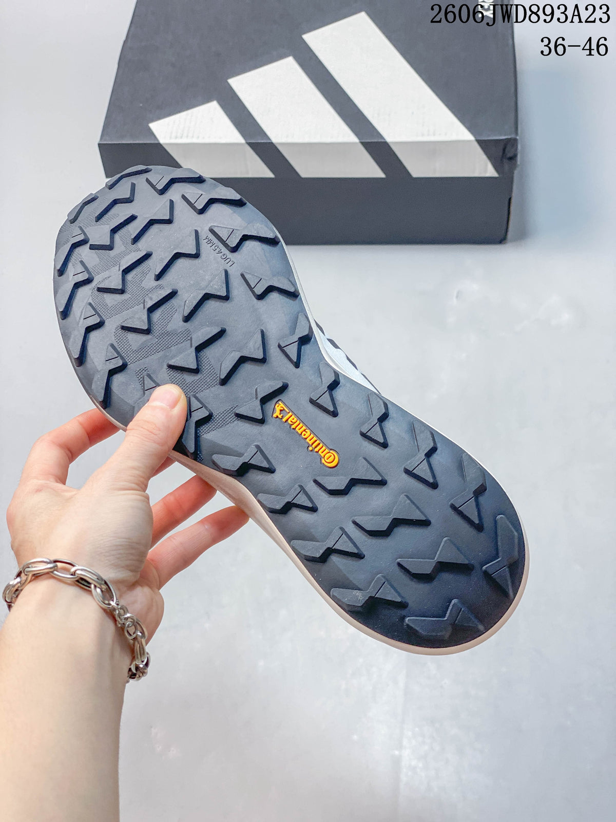 Close-up of the trail shoes' dark outsole with raised tread lugs.