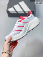Side profile showing the white upper, red accent stripes, layered white midsole and burgundy outsole.