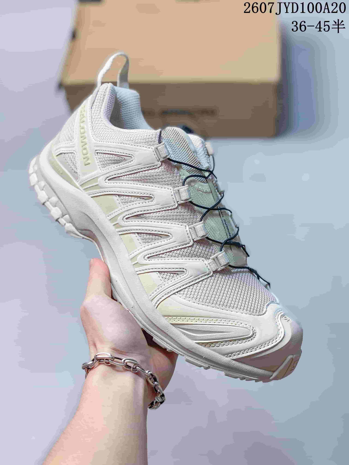 White Salomon XA PRO 3D trail shoe with pale green accents and a lugged outsole.