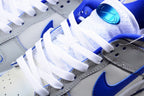 Close-up of the white laces, blue tongue detail, perforations, and side branding.