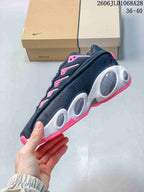Side view showing the patterned upper, rounded midsole details and pink accents