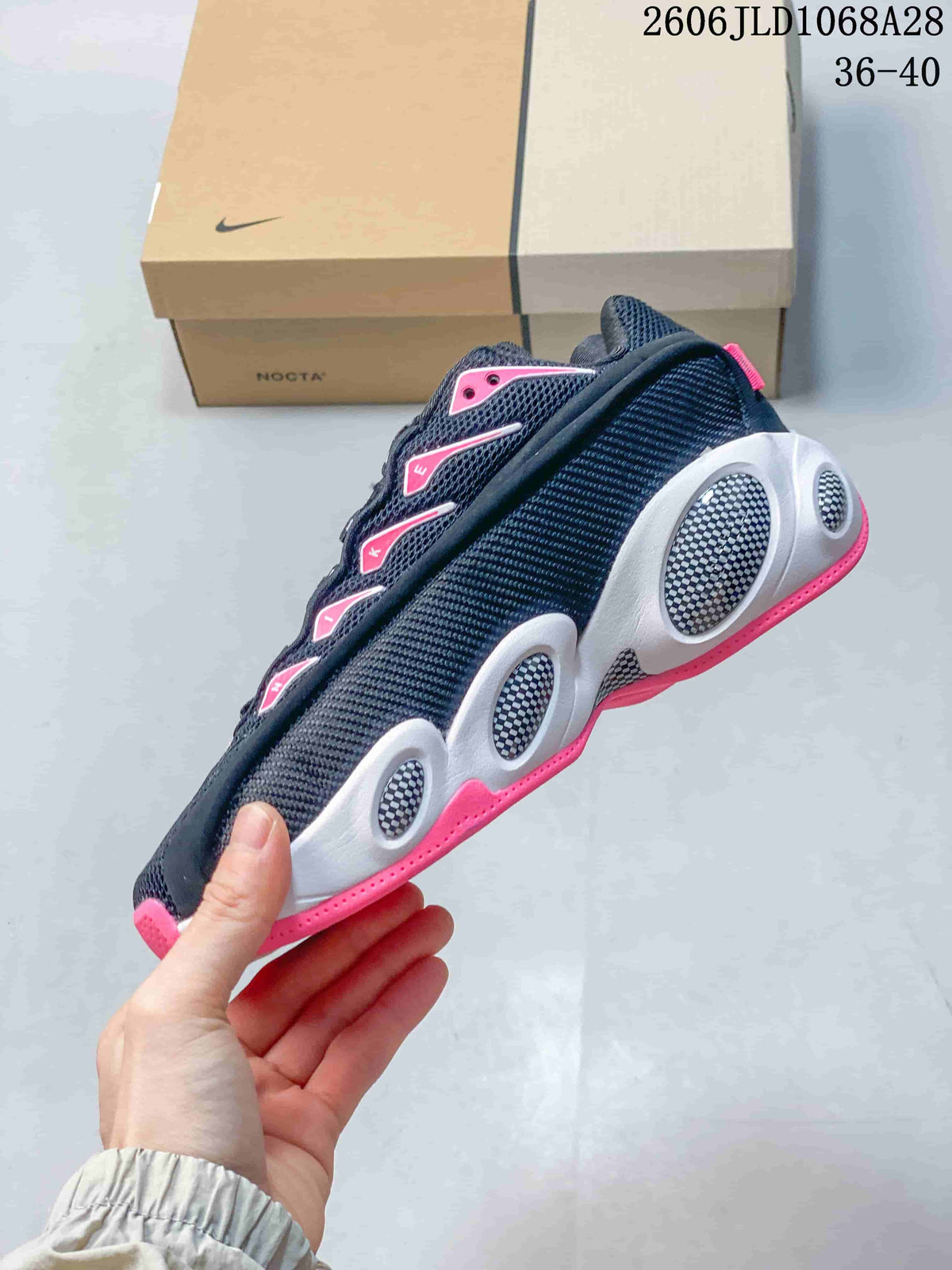 Side view showing the patterned upper, rounded midsole details and pink accents