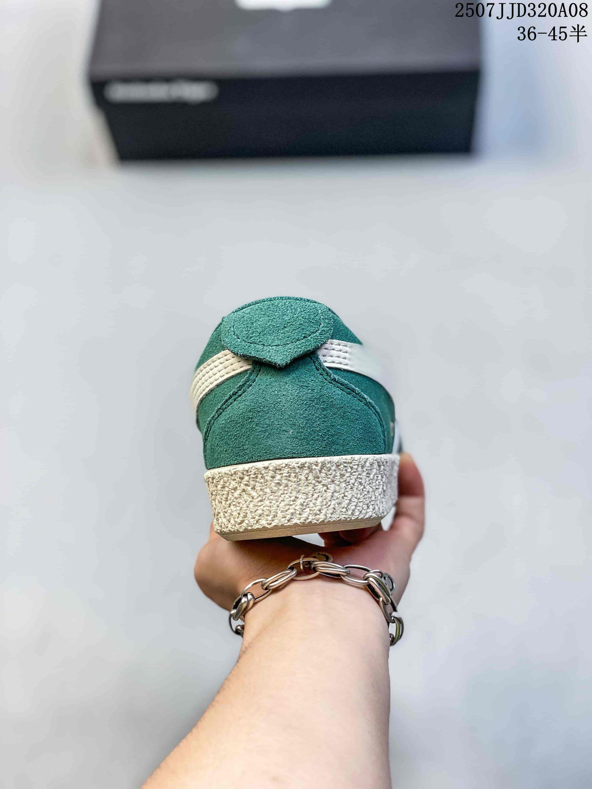 Rear view of the green sneaker with a cream stripe detail and cream outsole.
