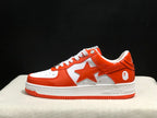 Side profile of a white and orange BAPE Sta sneaker showing the star-shaped side detail and contrasting outsole.