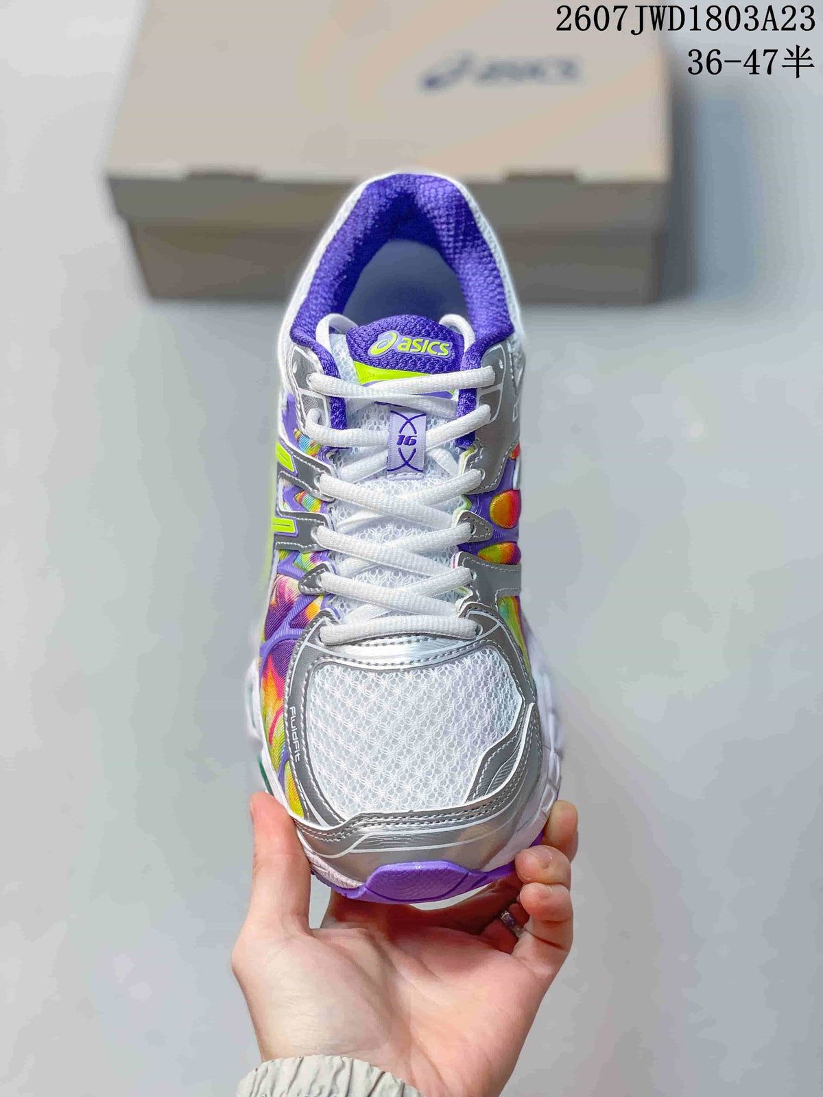Top view of the ASICS sneaker showing white laces, a white textured toe area, silver overlays, and purple collar lining.