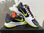 Pair of Nike basketball shoes showing the side panels, bright yellow-green Swooshes, burgundy laces, and speckled midsoles.