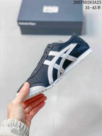 Side view of the black and white sneaker showing the contrasting stripes and textured outsole.