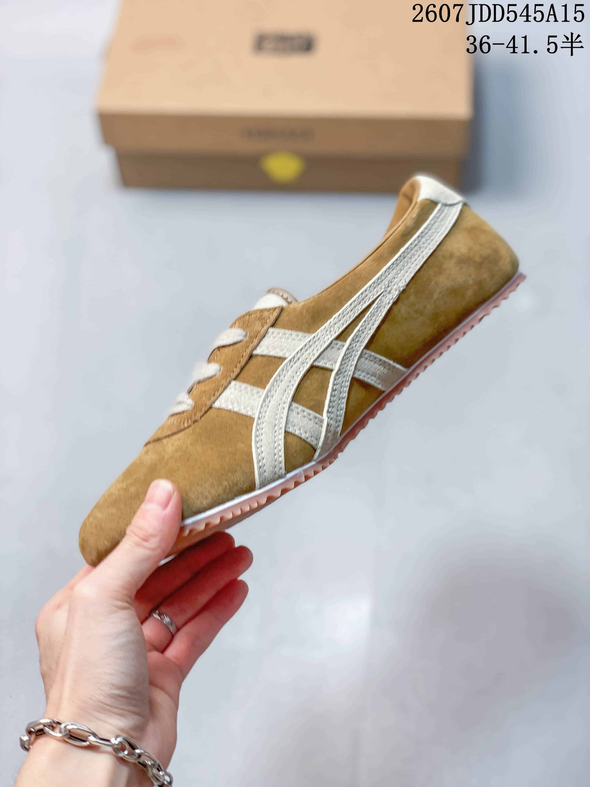 Side view of the tan low-top sneaker showing cream crossed side stripes, suede-textured panels, laces, and pink outsole.