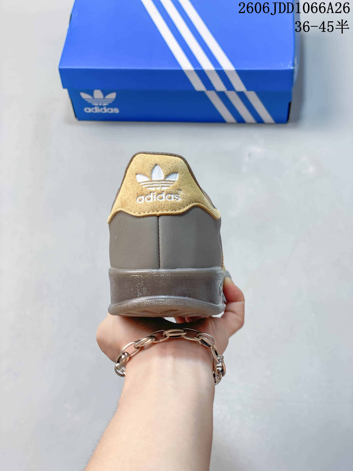 Rear view showing the gray heel, gold-toned heel tab, and Adidas Trefoil branding.