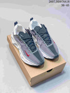 Pair of gray, white, and red Nike sneakers displayed on a shoebox, with style code and size range text visible above.