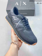 Side view of a navy AX sneaker with mesh panels and a gum-tone outsole.