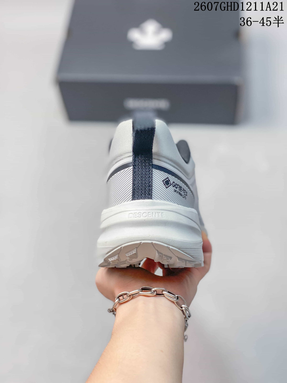 Rear view of the sneaker showing the pull tab, padded heel, DESCENTE branding, and outsole tread.
