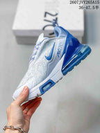 Side view showing the perforated upper, blue Nike Swoosh, Air Max heel, and white midsole.