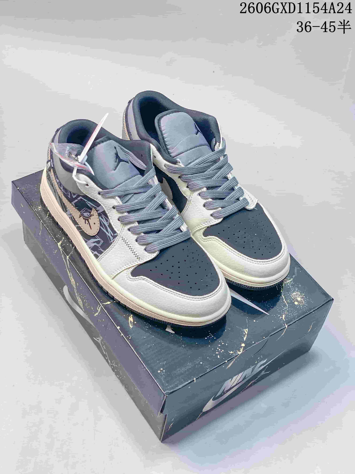 Pair of gray, cream, and navy low-top sneakers displayed on a shoebox