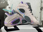 Two pale pink basketball shoes shown from the side, with purple trim and multicolor patterned details.