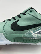Side close-up of the black Swoosh and green upper