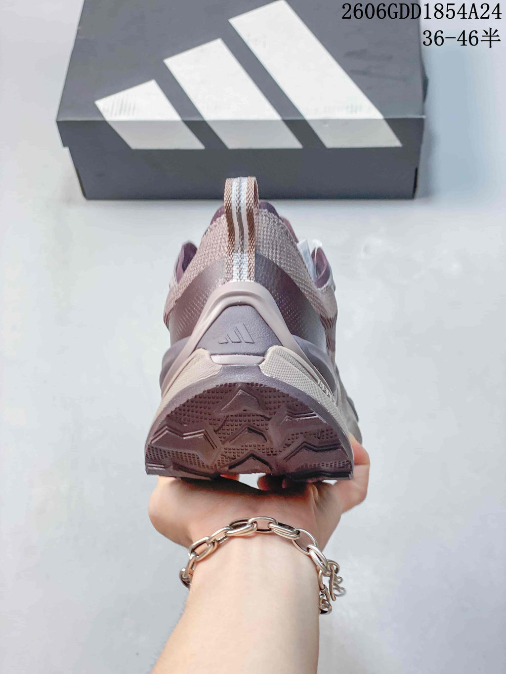 Rear view of a mauve Adidas trail running shoe showing the heel and outsole
