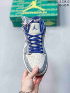 Front view showing blue laces, tongue logo, perforated toe box and grey overlays.