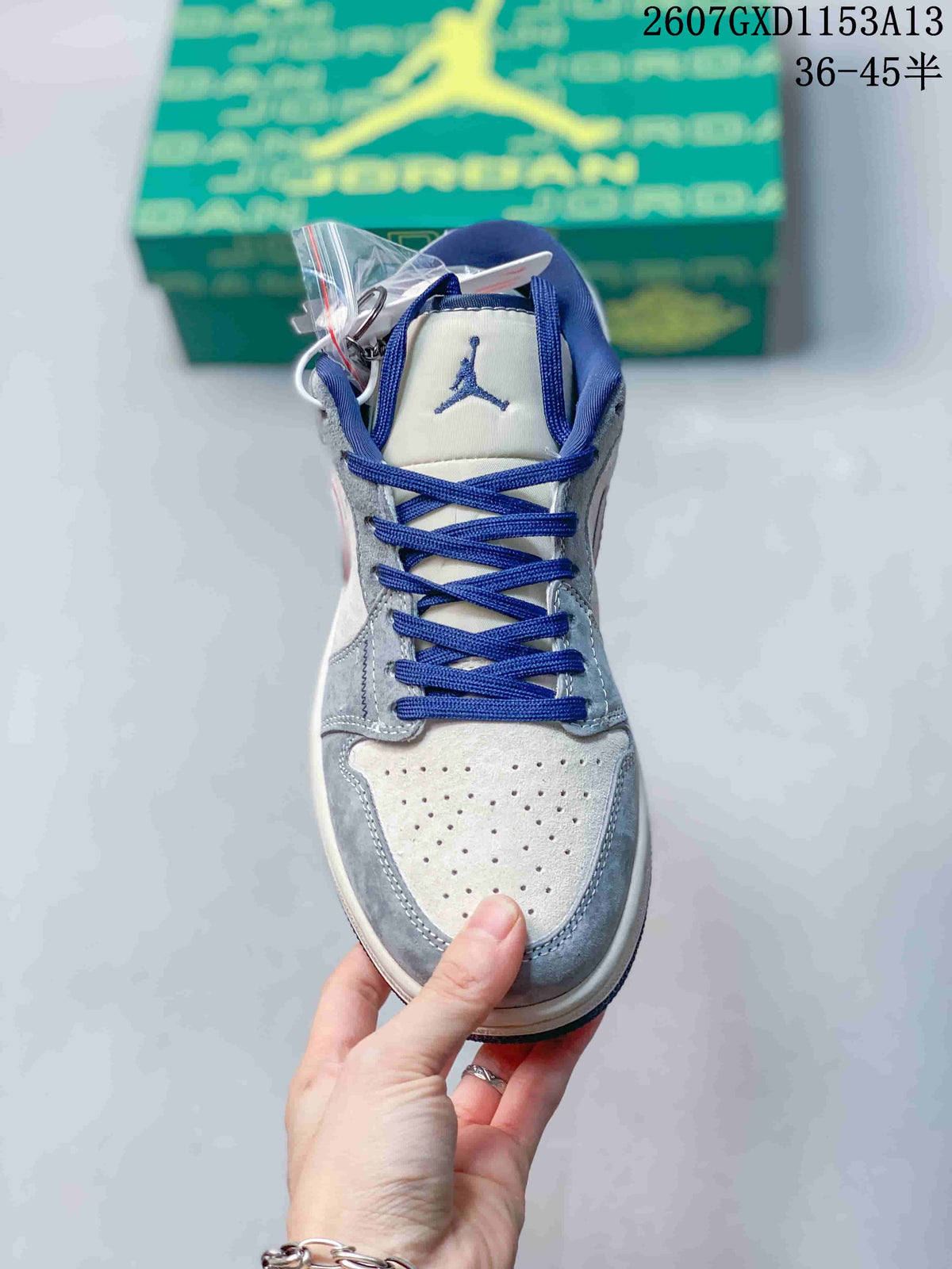 Front view showing blue laces, tongue logo, perforated toe box and grey overlays.