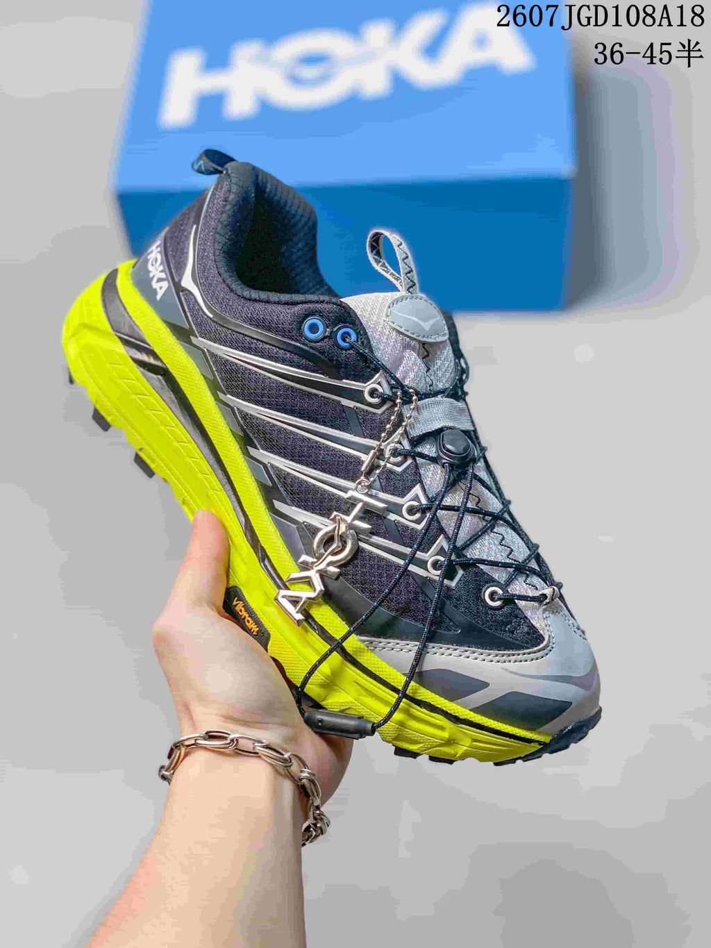 Black and gray HOKA Mafate Speed 2 sneaker with a bright yellow-green midsole and outsole accent.