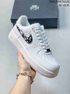Angled view of a white low-top sneaker with a glossy black side logo.