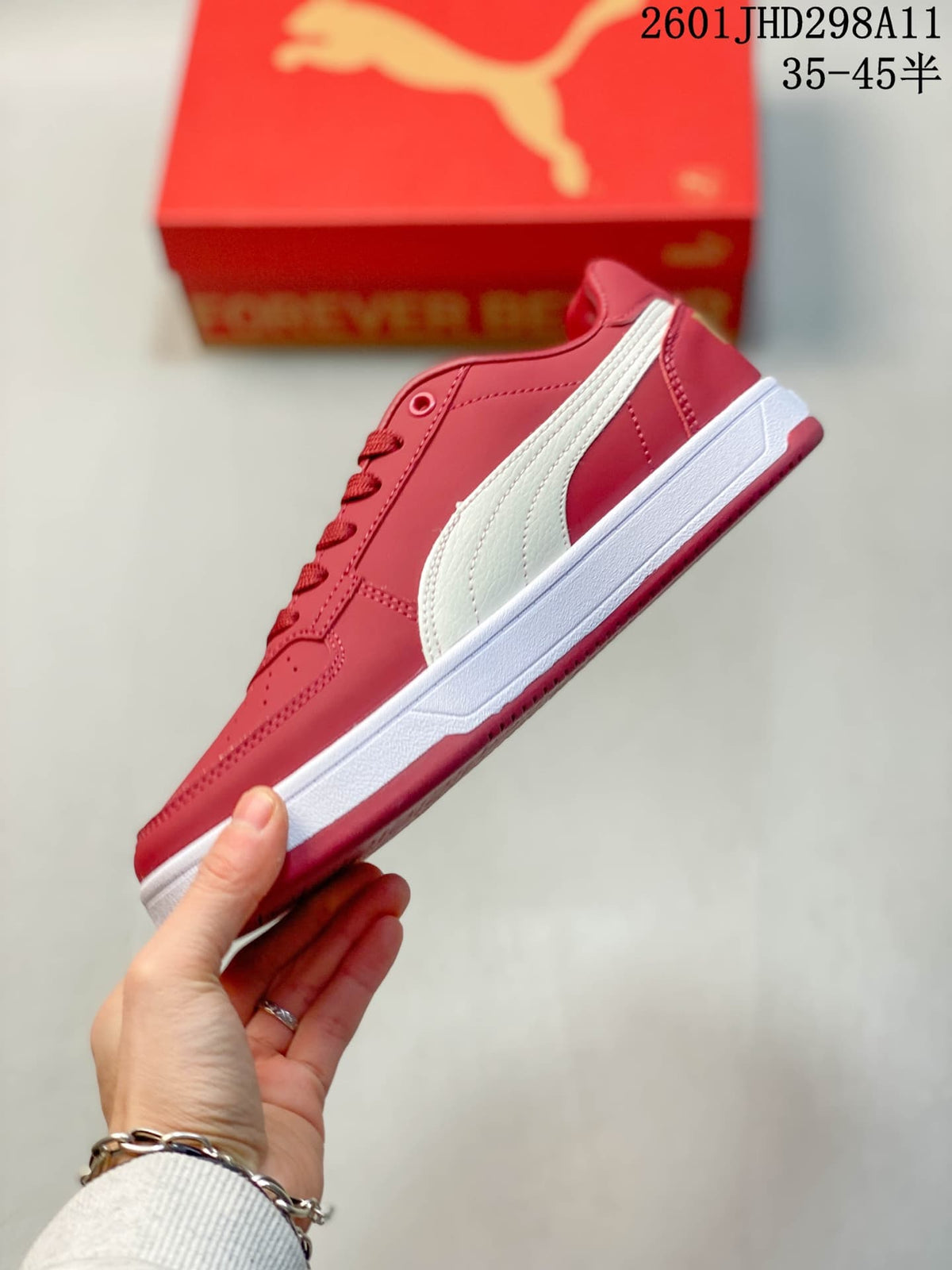 Side view showing the red upper, white Puma side stripe, and white midsole.