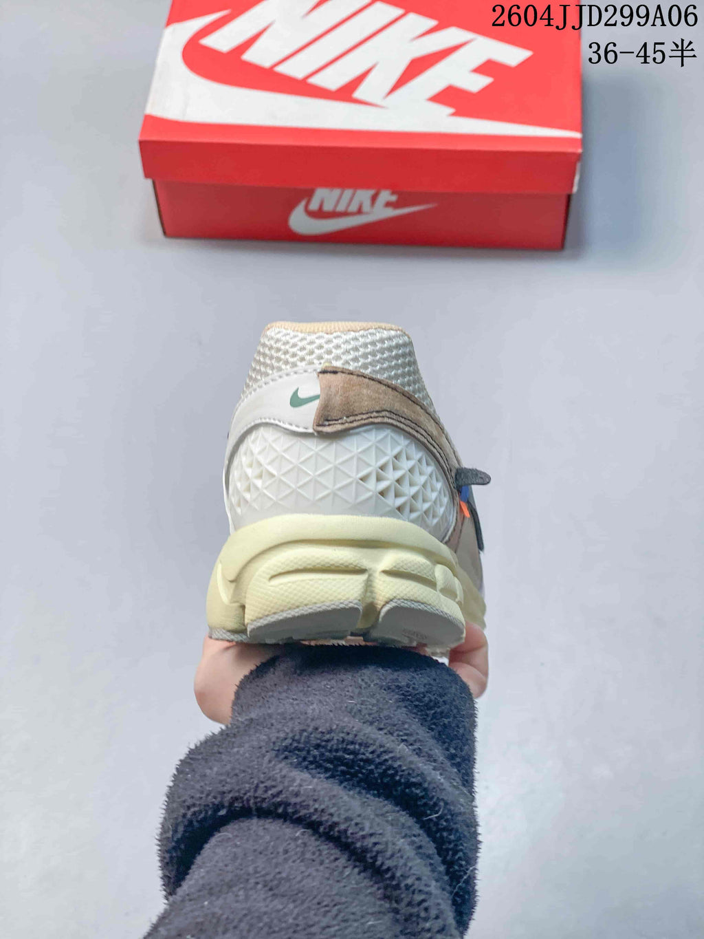 Rear view of the Nike Zoom Vomero 5 sneaker showing the textured heel area and cream-colored cushioning structure.