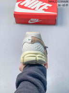 Rear view of the Nike Zoom Vomero 5 sneaker showing the textured heel area and cream-colored cushioning structure.