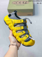 Yellow and dark gray Keen sandal with adjustable webbing straps, quick-lacing hardware and a protective toe bumper; the image includes the size range 36–45.