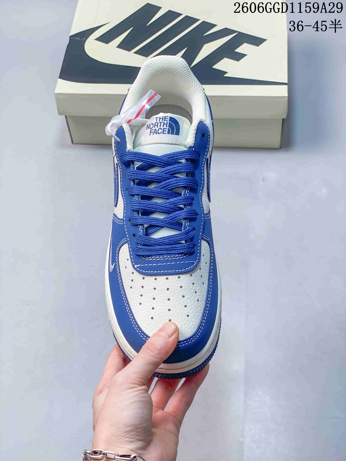 Top view of the sneaker showing blue laces and a perforated white toe panel.
